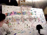 Attendees coloring the mural.